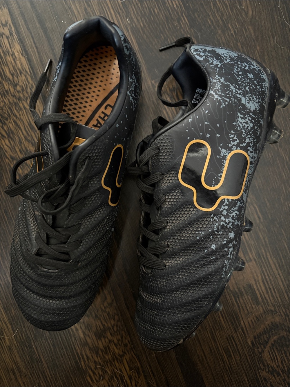 Women’s Black Soccer Cleats with gold Accent